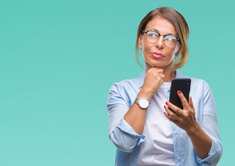 Sticker - Middle age senior woman texting sending message using smartphone over isolated background serious face thinking about question, very confused idea