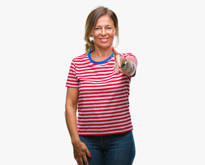 Canvas Print - Middle age senior hispanic woman over isolated background smiling friendly offering handshake as greeting and welcoming. Successful business.