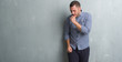 © Krakenimages.com - Young caucasian man over grey grunge wall feeling unwell and coughing as symptom for cold or bronchitis. Healthcare concept.