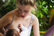 © Alexander - portrait of a beautiful young mother breastfeeding her newborn baby in the garden