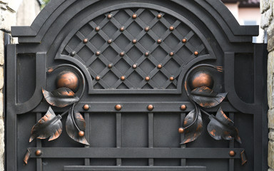 Wrought-iron gates, ornamental forging, forged elements close-up.