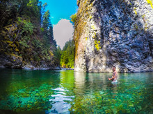 Young Beautiful Woman Swims In Crystal Clear Green River Mermaid