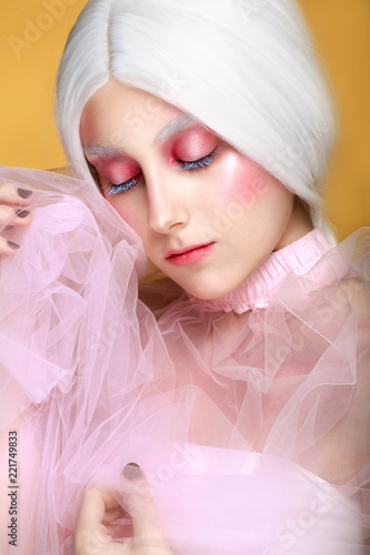 Girl With Long White Hair And Purple Eyes Isolated On A Yellow