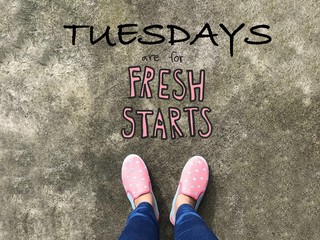 Tuesdays are for fresh starts word and woman pink sneaker shoes background 