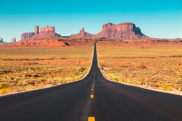 Wall Mural - Classic highway view in Monument Valley at sunset, USA