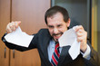 Angry businessman tearing up a document