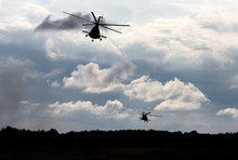Military Helicopters Fly In The Sky