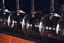 Wine Glasses Stand Upside Down On The Bar In The Restaurant, An Abstract Bar Image, An Image With Retro Toning