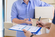 © PRIME STOCK LAB - Young male startup small business owner sending order packaging to customer and sign on invoice bill. Business owner working at home office. freelance working concept.