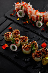 Wall Mural - close-up view of roll in mamenori with shrimp, salmon and avocado in sauce nigiri and roll with creamy eel and kimchi mayonnaise