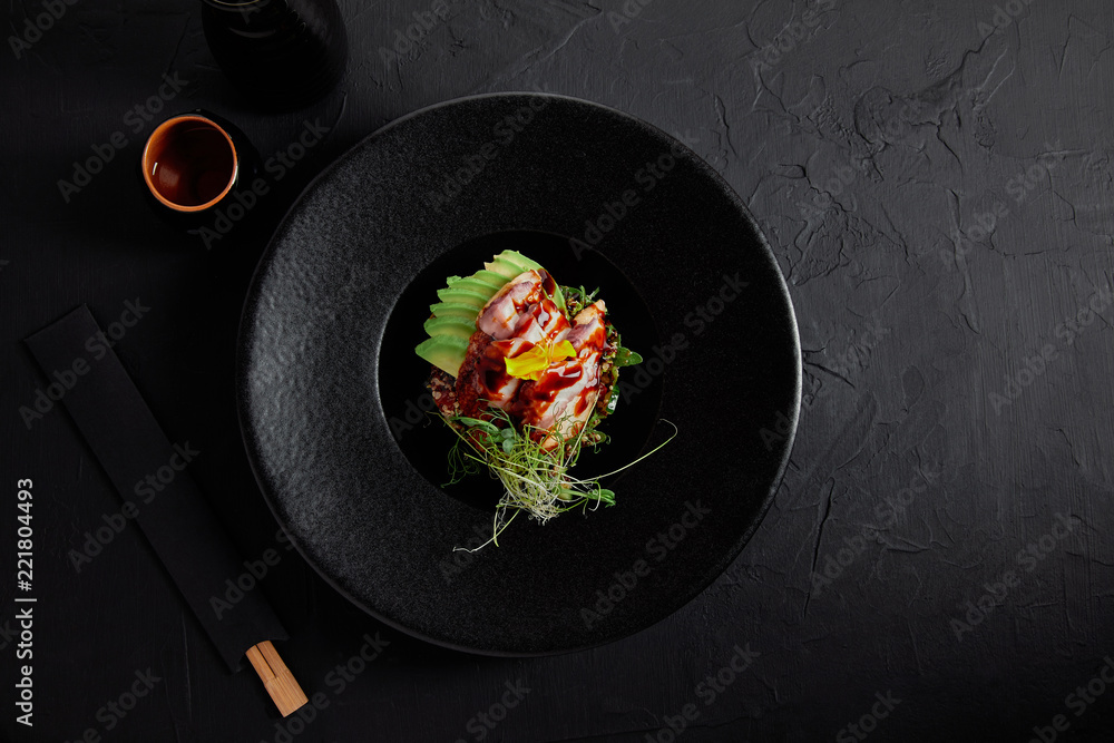 top view of delicious traditional japanese dish with seafood, avocado and herbs on black plate - obrazy, fototapety, plakaty 