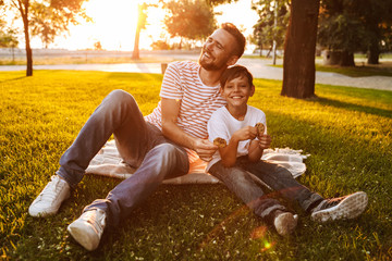 Wall Mural - Happy father spending time with his little son at the park