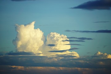 Wall Mural - dramatic cloudscape with sunset colors and blue sky
