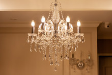 Chrystal Chandelier Lamp On The Ceiling In Dining Room Adjusting The Image In A Luxury Tone .Decorative Elegant Vintage And Contemporary Interior Concept.