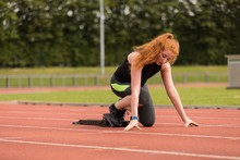 Female Athlete Ready To Run On Running Track