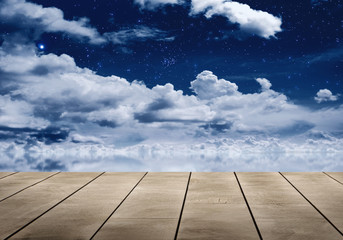 Wall Mural - wooden table top with starry night sky reflective on water