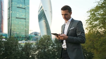 Young caucasian man holding smartphone for business work.