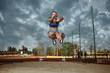 © master1305 - Female athlete performing a long jump during a competition at stadium. The jump, athlete, action, motion, sport, success, championship concept