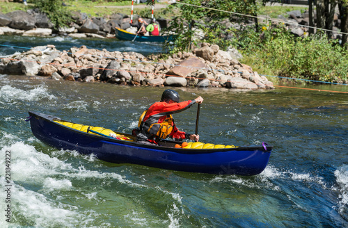 Fotografía Paddling a whitewater equipped canoe through the rapids .