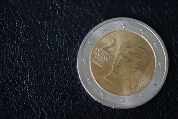 Coin in two euros on  a dark background close up