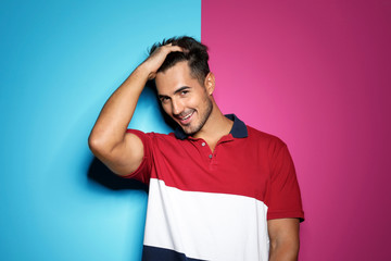 Poster - Young man with trendy hairstyle posing on color background