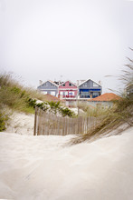 Lovely And Quaint Beach Houses Seen From Beach Dunes. Beach Houses With Colorful Stripes From Costa Nova, Portugal.
