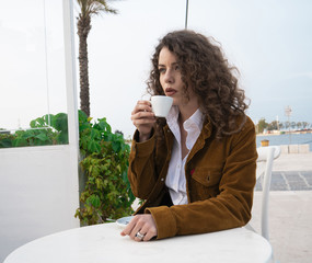 Wall Mural - pretty girl in a cafe drinking coffee