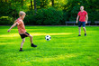 © spass - Happy young father play with his little son football in sunny park
