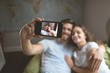 © Wavebreak Media - Couple taking selfie with mobile phone