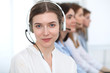 © rogerphoto - Call center. Beautiful cheerful smiling operator consulting clients with headset. Business concept of customer service