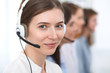 © rogerphoto - Call center. Beautiful cheerful smiling operator consulting clients with headset. Business concept of customer service
