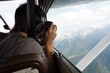© Wavebreak Media - Pilot taking photos with camera while flying