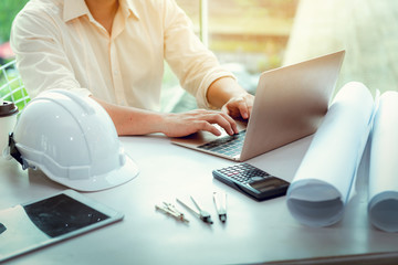 close up portrait of civil engineer using laptop to planning project schedule, engineering and const
