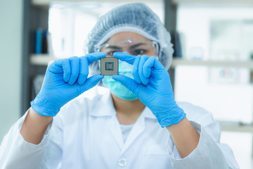 Portrait of computer engineer is holding CPU's computer for examination