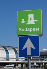 budapest and one way street sign with budapest airport building in the background