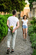 © be free - Surprise for her. Man hides flower bouquet behind back while waits girl romantic date. Couple meeting for date park background. Guy prepared surprise for girlfriend. First impression always important