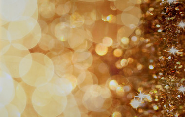 Christmas background. Golden holiday abstract glitter defocused background with blinking stars. Blurred bokeh