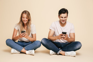 Wall Mural - Portrait of a happy young couple sitting together