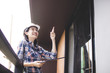 © khwanchai - Happy young engineer woman inspection checking work in renovation building