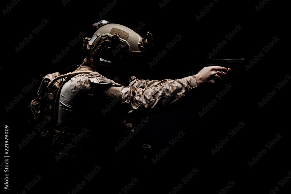 soldier or private military contractor holding rifle. Image on a black ...