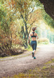 Active beautiful woman running in the park. Healthy lifestyle