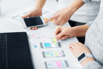 app design, technology and business concept - web designers or developers with smartphone working on user interface at office