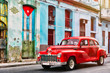 Classic car and and old building with the cuban flag in Old Havana