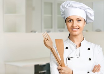 Wall Mural - Portrait of young woman chef on white