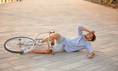 Wall Mural - Man fallen off his bicycle on street