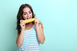 © 5second - Young woman eating corn on mint background