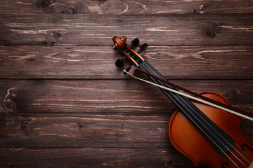 Wall Mural - Violin with bow on brown wooden table