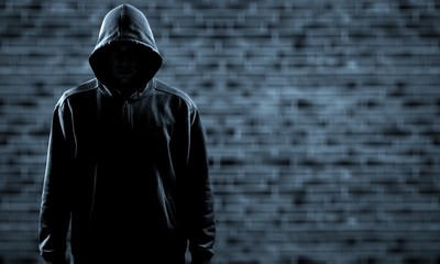 thief in black clothes on grey background