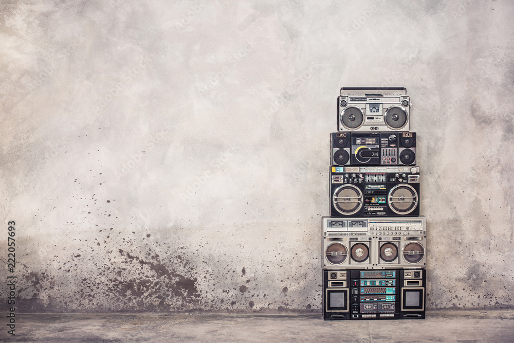 Retro old school design ghetto blaster boombox  stereo radio cassette tape recorders tower from circa 1980s front concrete wall background. Vintage style filtered photo - obrazy, fototapety, plakaty 