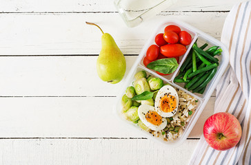 Wall Mural - Vegetarian meal prep containers with eggs, brussel sprouts, green beans and tomato. Dinner in lunch box. Top view. Flat lay